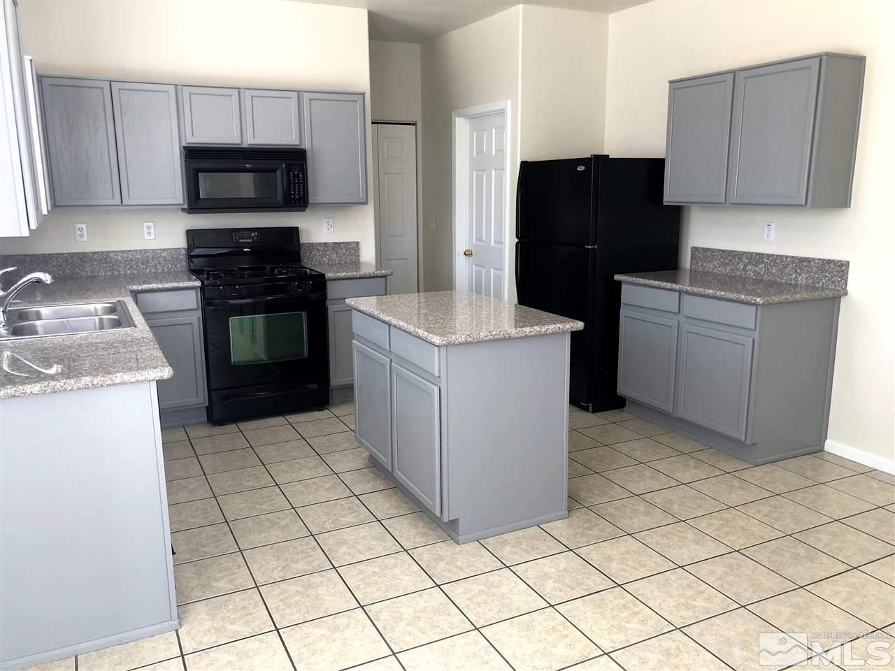 2288 Rio Lobo Lane Reno, NV 89521 - Photo 5 of 26 a kitchen with a stove a refrigerator and a sink