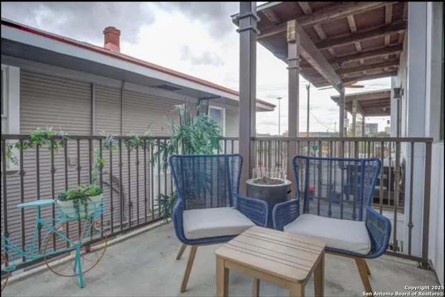 a view of a patio with table and chairs with wooden floor
