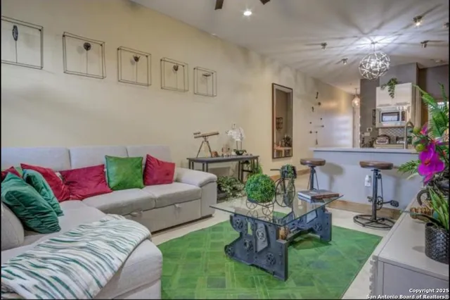 a living room with furniture and flowers