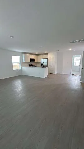 a view of a kitchen with a sink and dishwasher next to a window