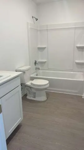 a bathroom with a toilet a sink and a bathtub