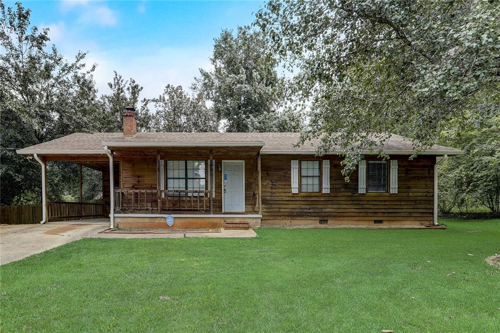 1586 Flat Rock Road Stockbridge, GA 30281 - Photo 1 of 1 a front view of a house with a yard table and chairs