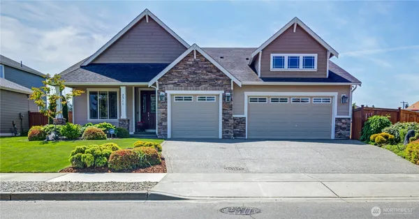 a front view of a house with a yard and garage