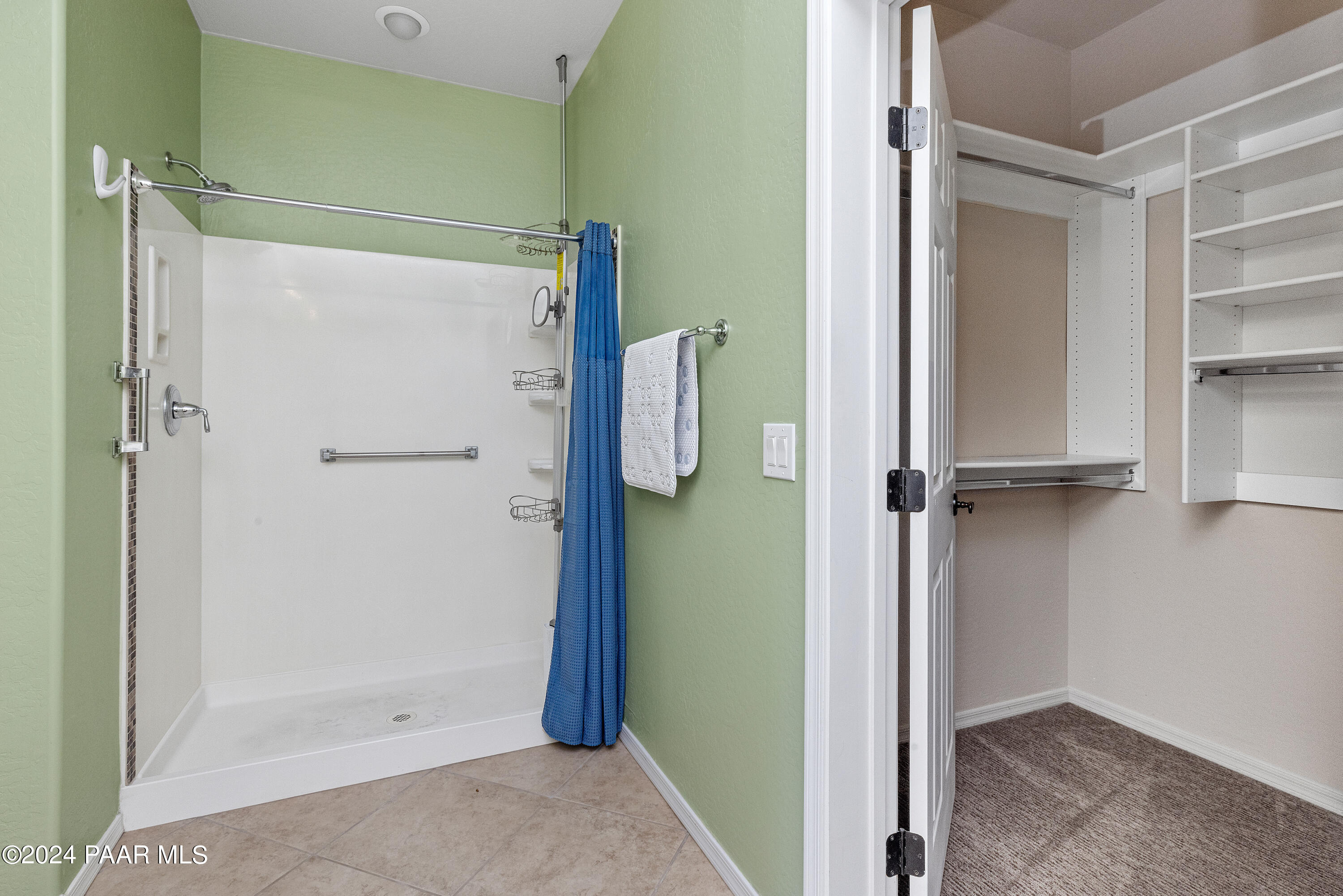 1195 Rigo Ranch Road Prescott Valley, AZ 86314 - Photo 12 of 65 a bathroom with a shower and a glass door