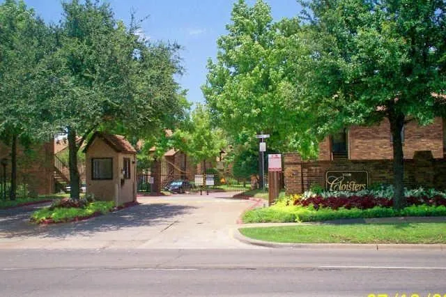 a front view of a house with a yard tree and outdoor seating