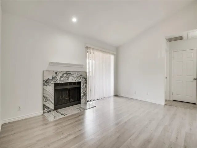 a view of a kitchen with a sink stove cabinets and empty room