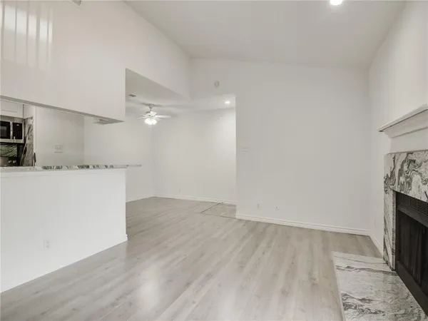 a view of a kitchen with wooden floor and electronic appliances