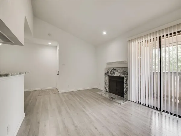 a view of cabinets with wooden floor and electronic appliances