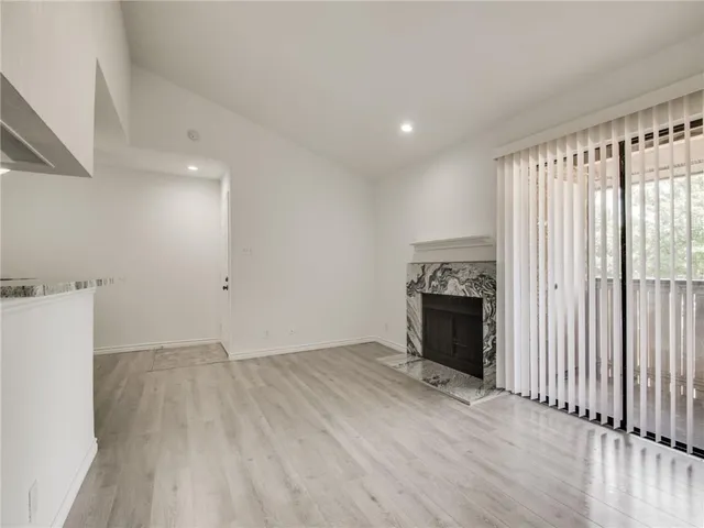 a view of cabinets with wooden floor and electronic appliances