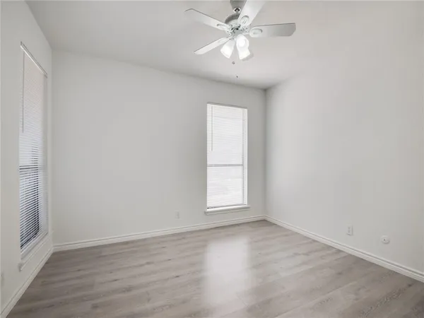a view of a room with wooden floor and fan