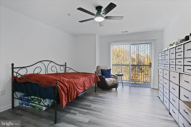 a spacious bedroom with a bed and a large window