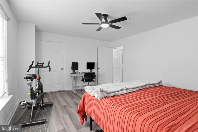 a bedroom with bed and a flat tv screen