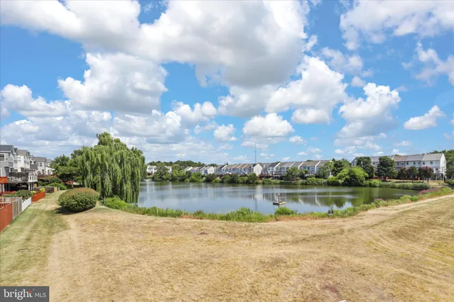 a view of a lake with houses in the back