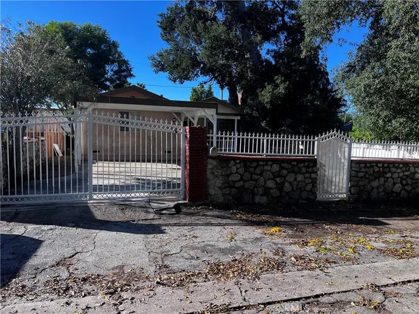 a view of a brick house with a small yard next to a yard