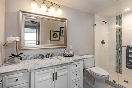 10120 United Place Cupertino, CA 95014 - Photo 15 of 30 a bathroom with a granite countertop sink a toilet and a mirror