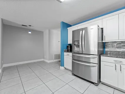 a kitchen with cabinets and stainless steel appliances