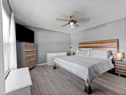 a bedroom with a bed and a television