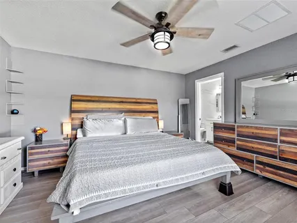 a bedroom with a bed and a chandelier