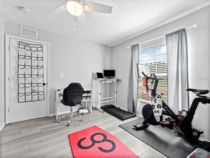 a view of a livingroom with workspace and a window