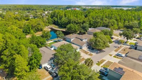 an aerial view of a house with a yard