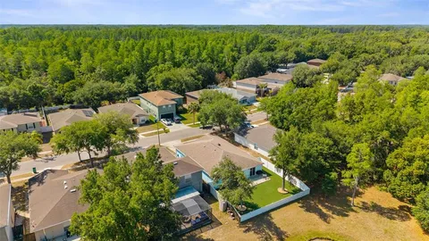 an aerial view of a house with a yard
