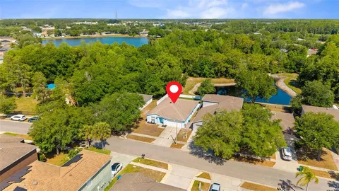 an aerial view of a house with a lake view