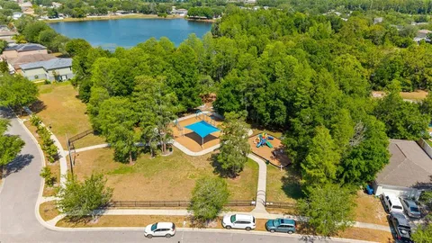 an aerial view of a house with a yard and lake view