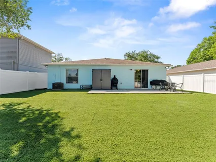 a view of a house with a backyard
