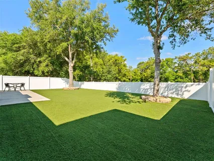 a view of a backyard with swimming pool