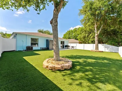a view of a house with a backyard porch and sitting area