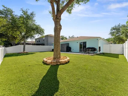 a swimming pool with some trees in the background