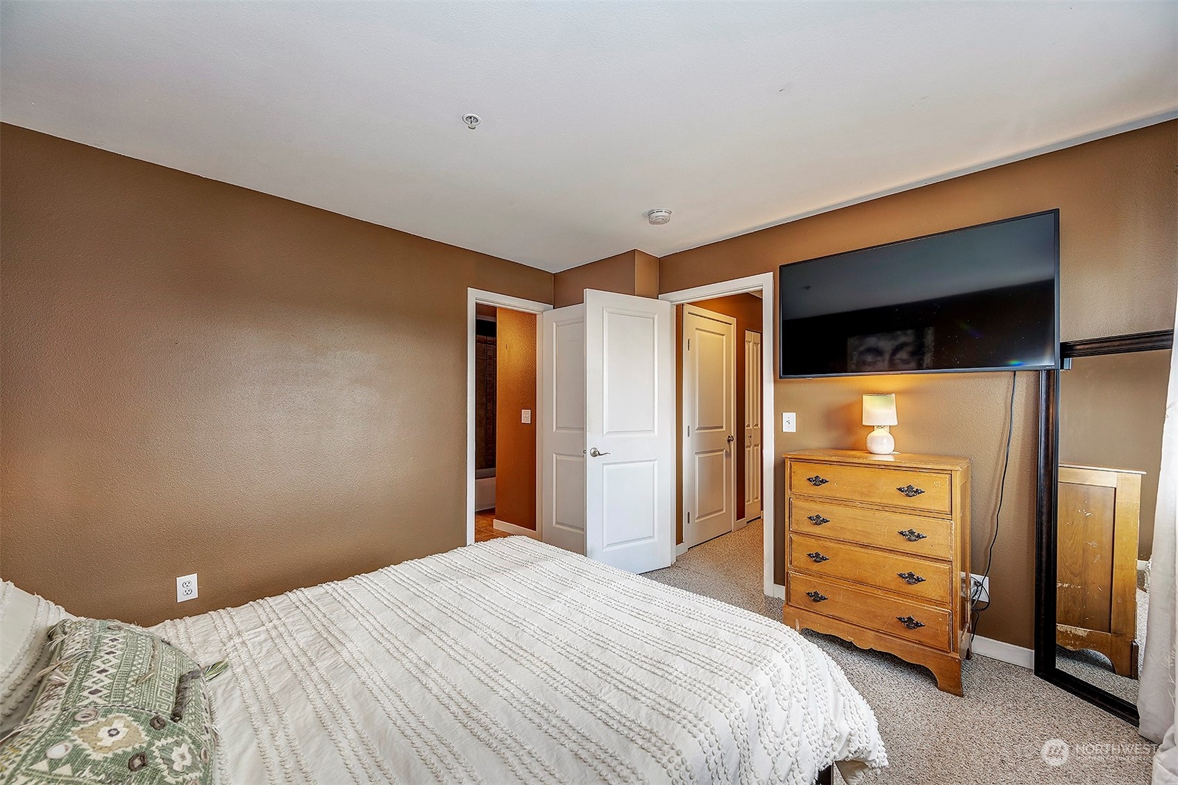 3918 243rd Place Southeast, Unit F303 Bothell, WA 98021 - Photo 14 of 23 a bedroom with a bed and a television