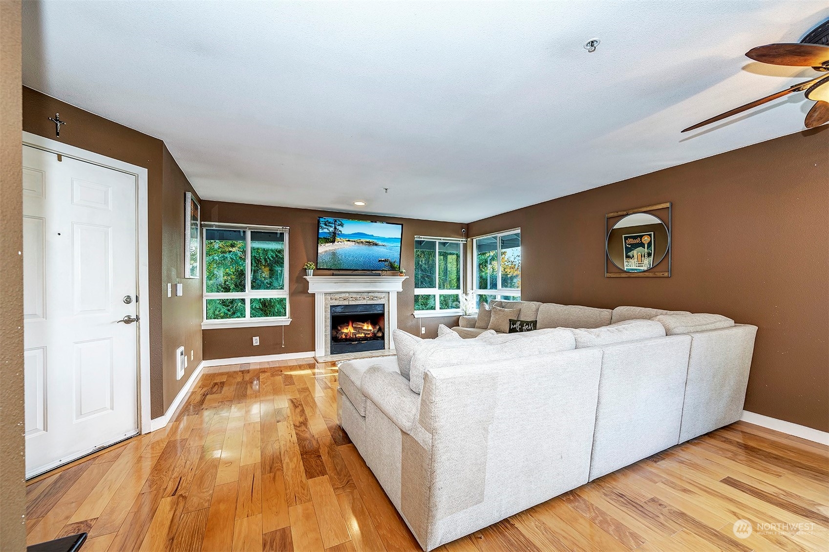 3918 243rd Place Southeast, Unit F303 Bothell, WA 98021 - Photo 6 of 23 a living room with furniture and a fireplace