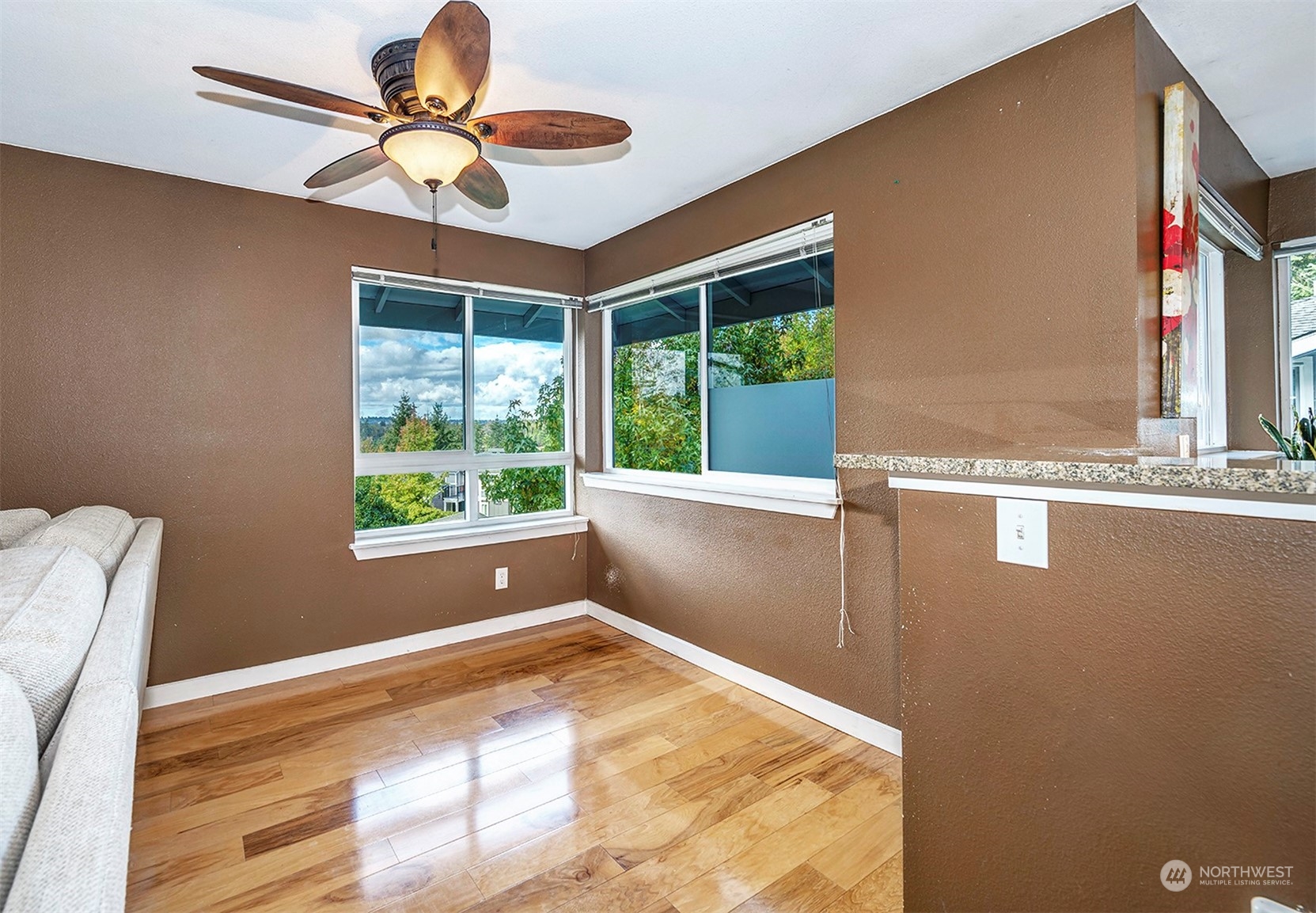 3918 243rd Place Southeast, Unit F303 Bothell, WA 98021 - Photo 8 of 23 a view of a livingroom with a ceiling fan and window