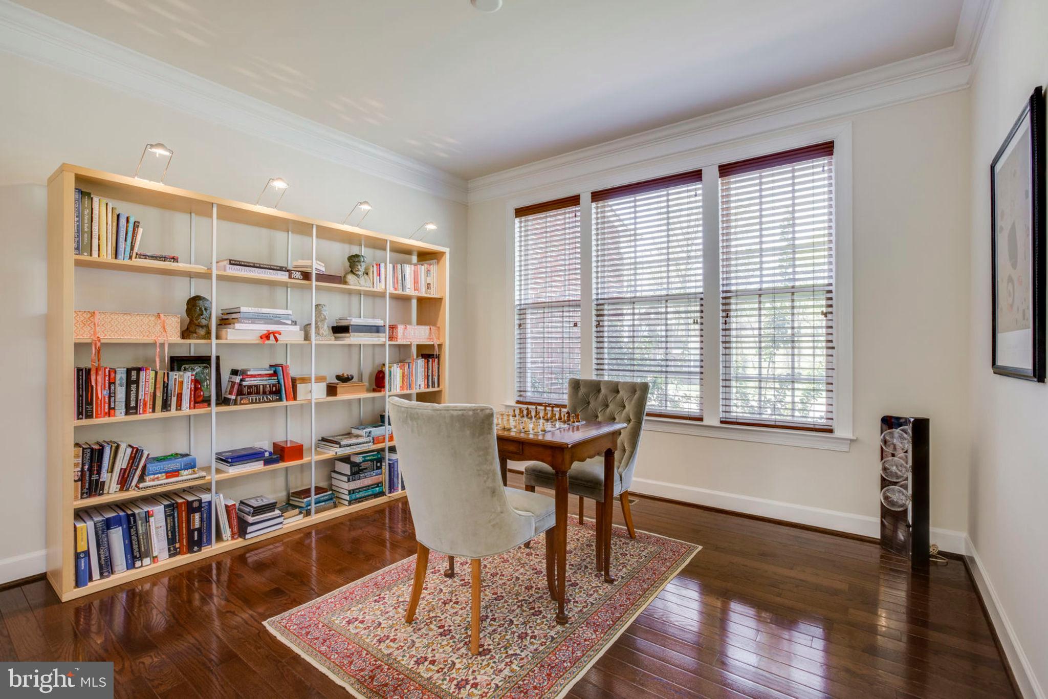 1299 Scotts Run Road McLean, VA 22102 - Photo 19 of 22 a view of a work space with furniture and a book shelf