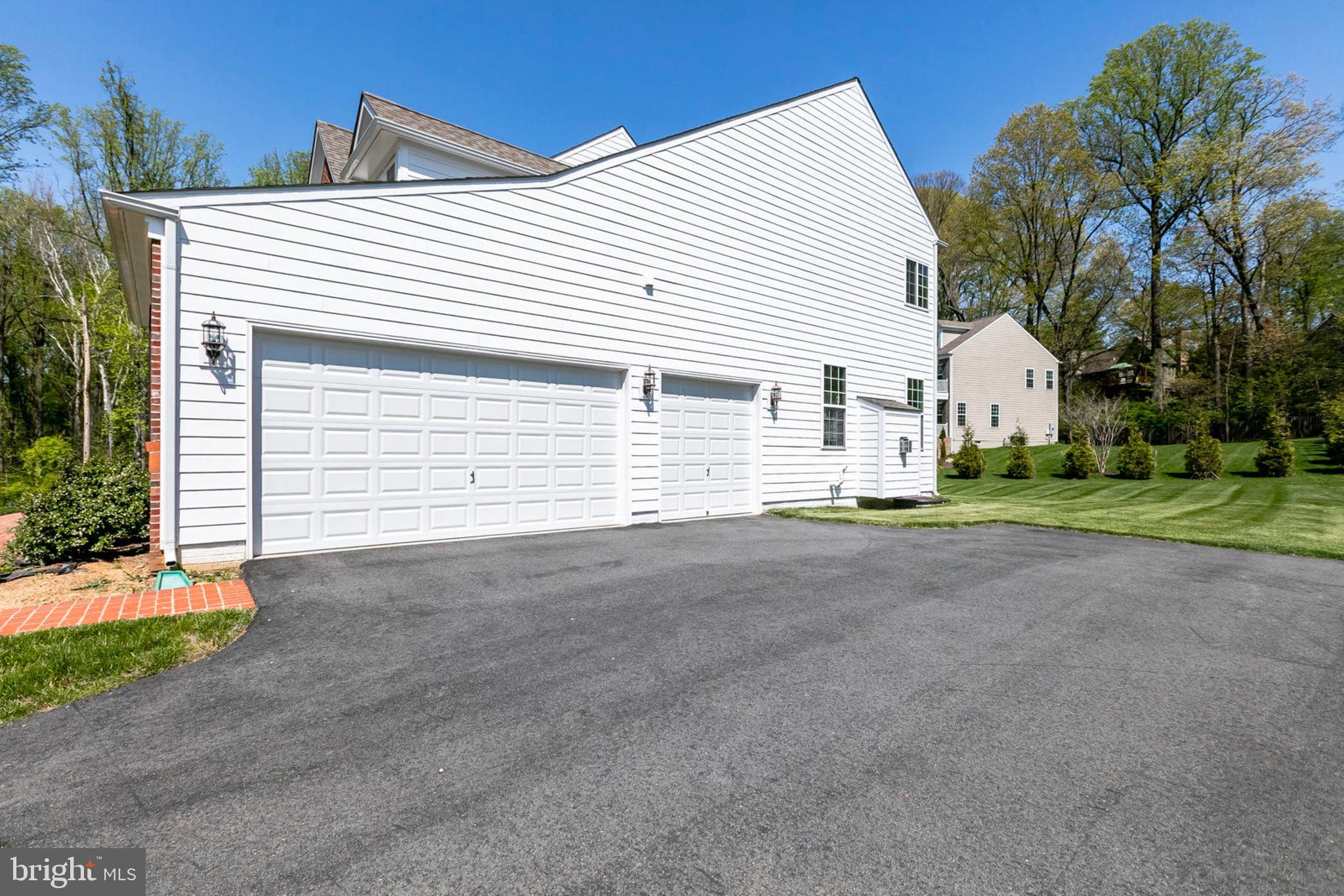 1299 Scotts Run Road McLean, VA 22102 - Photo 21 of 22 a view of a white house with a yard and garage