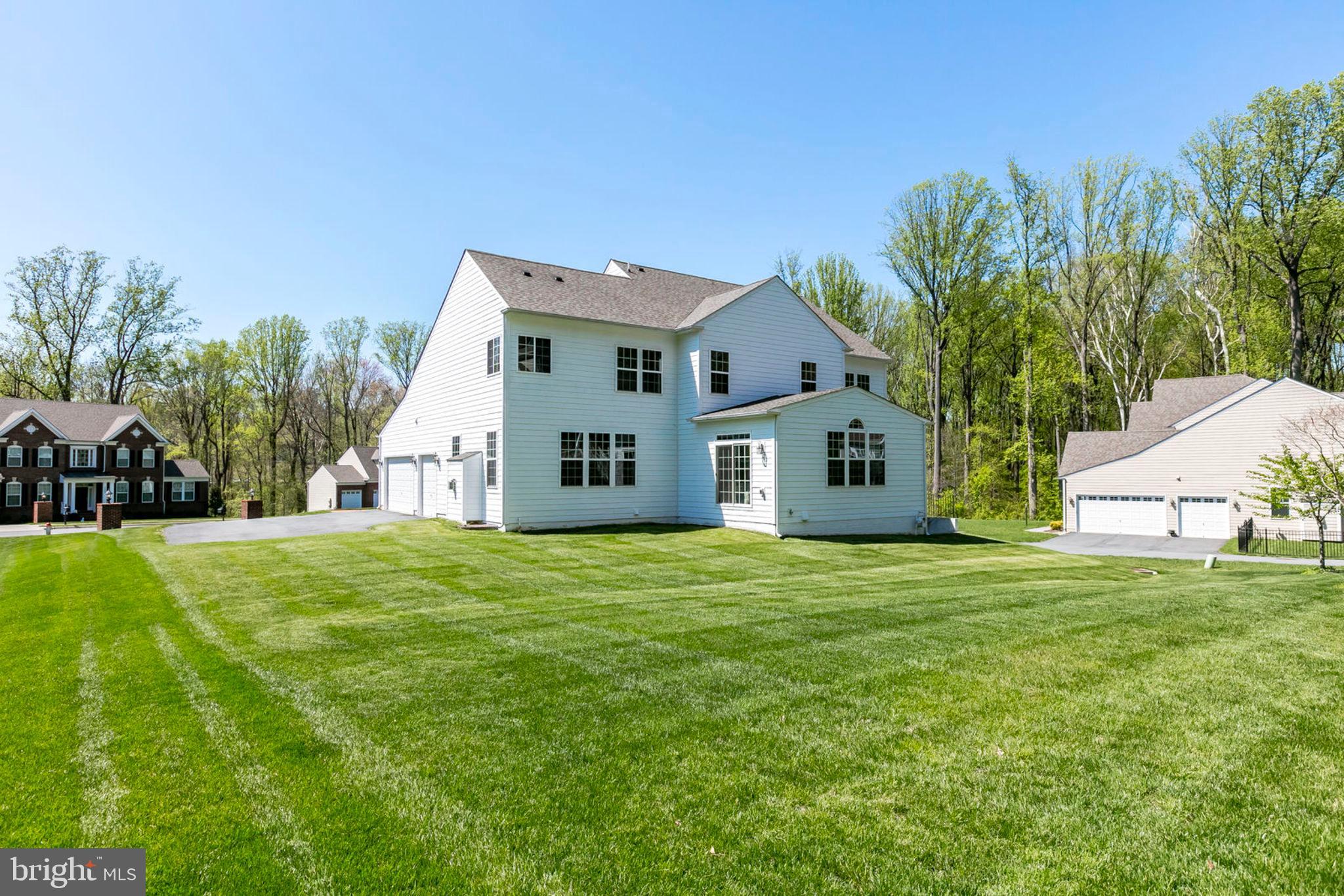 1299 Scotts Run Road McLean, VA 22102 - Photo 5 of 22 a front view of a house with a yard and trees