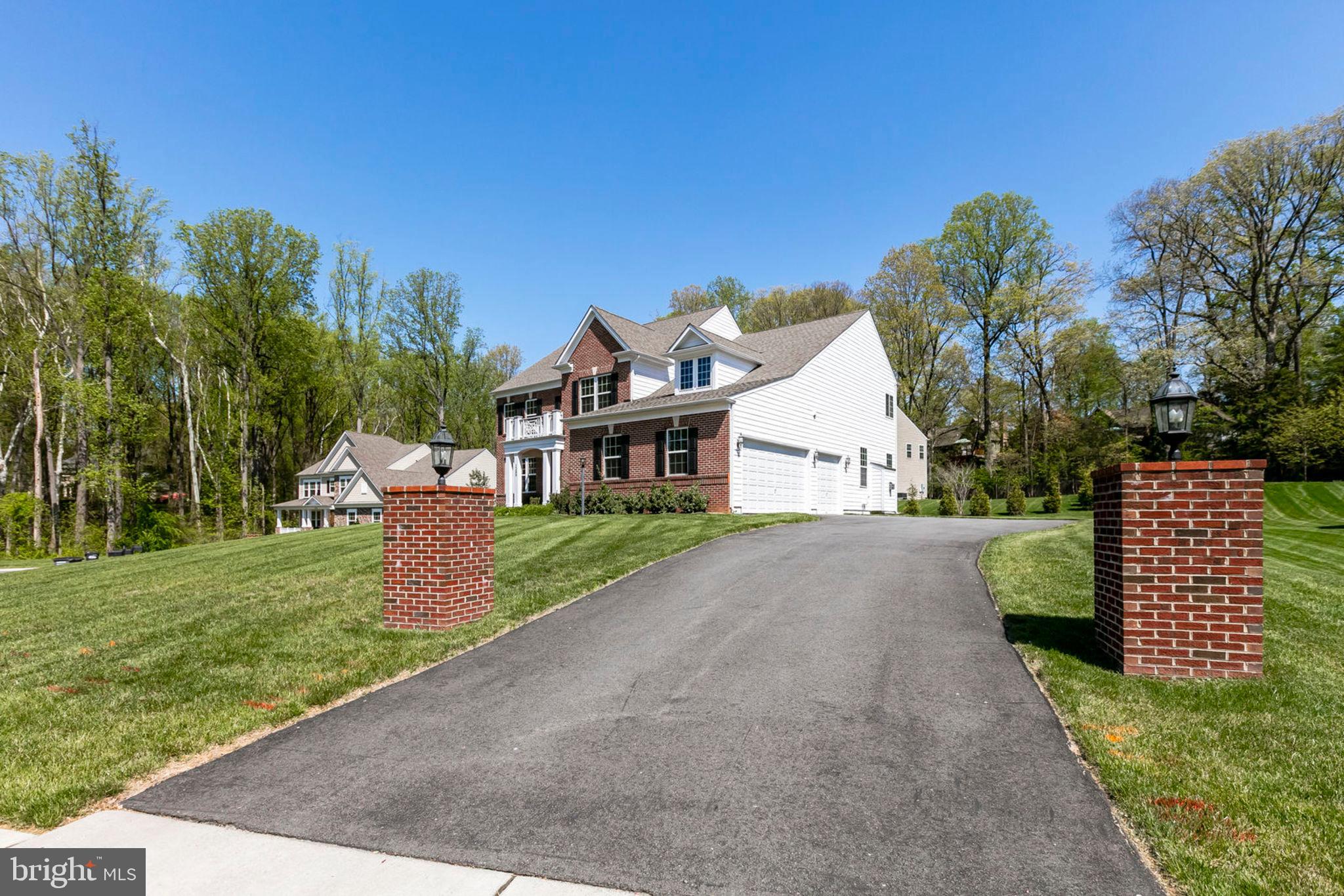 1299 Scotts Run Road McLean, VA 22102 - Photo 6 of 22 a front view of a house with a yard and garage