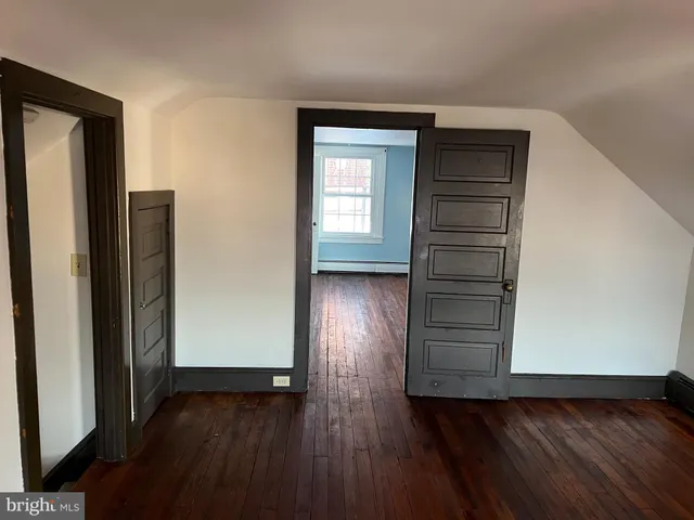 a view of hallway with wooden floor