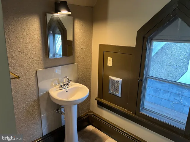 a bathroom with a sink a mirror and shower