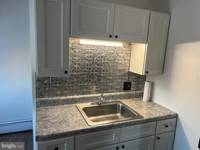 a kitchen with a sink and cabinets