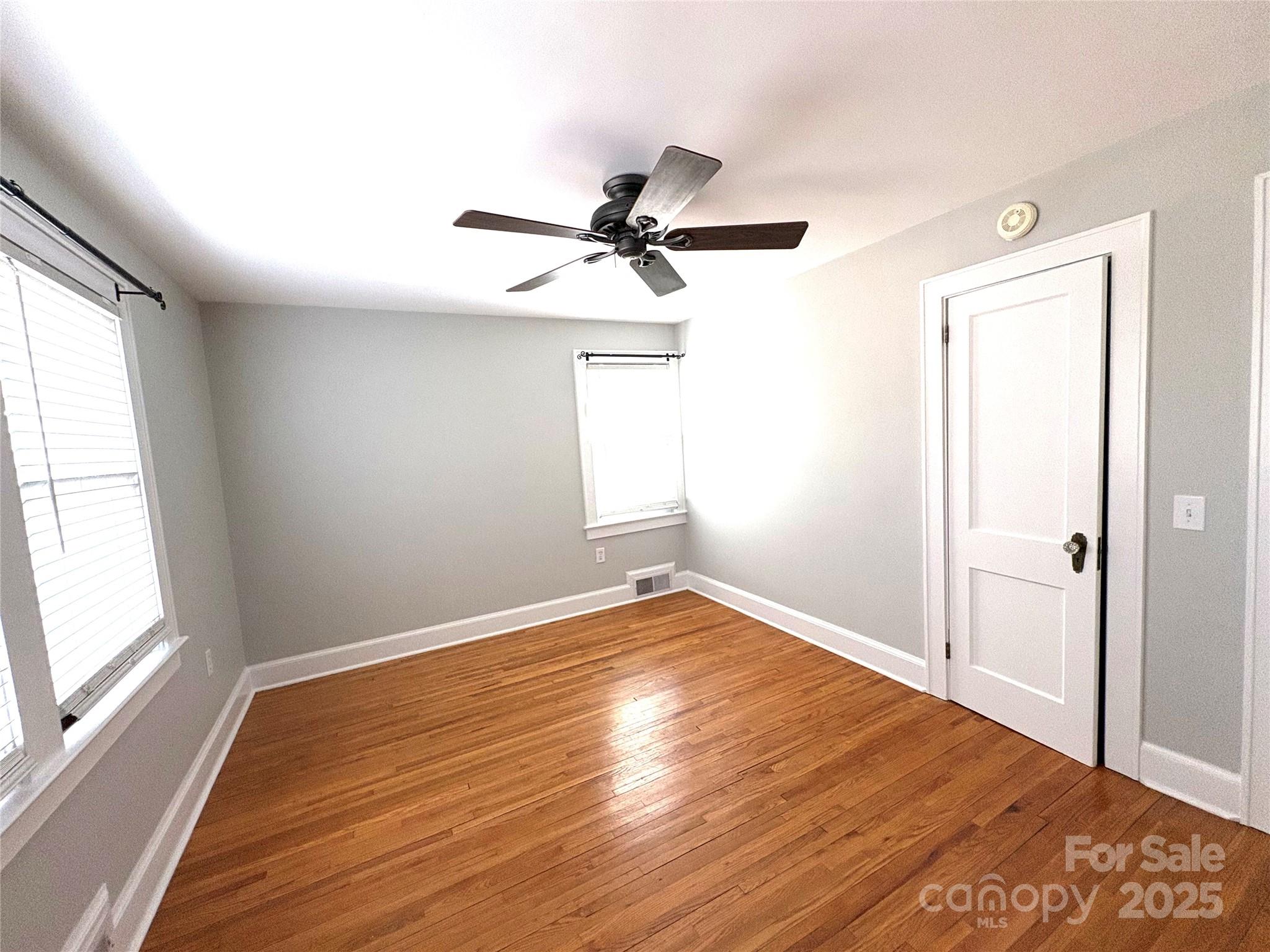 114 Broadway Tryon, NC 28782 - Photo 16 of 41 wooden floor in an empty room with a window