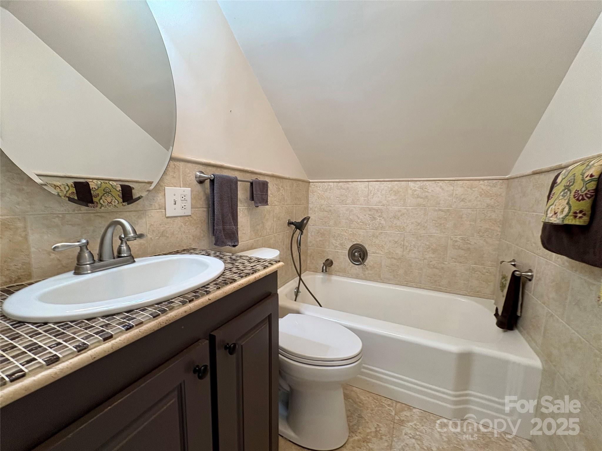 114 Broadway Tryon, NC 28782 - Photo 25 of 41 a bathroom with a granite countertop sink a toilet and bathtub