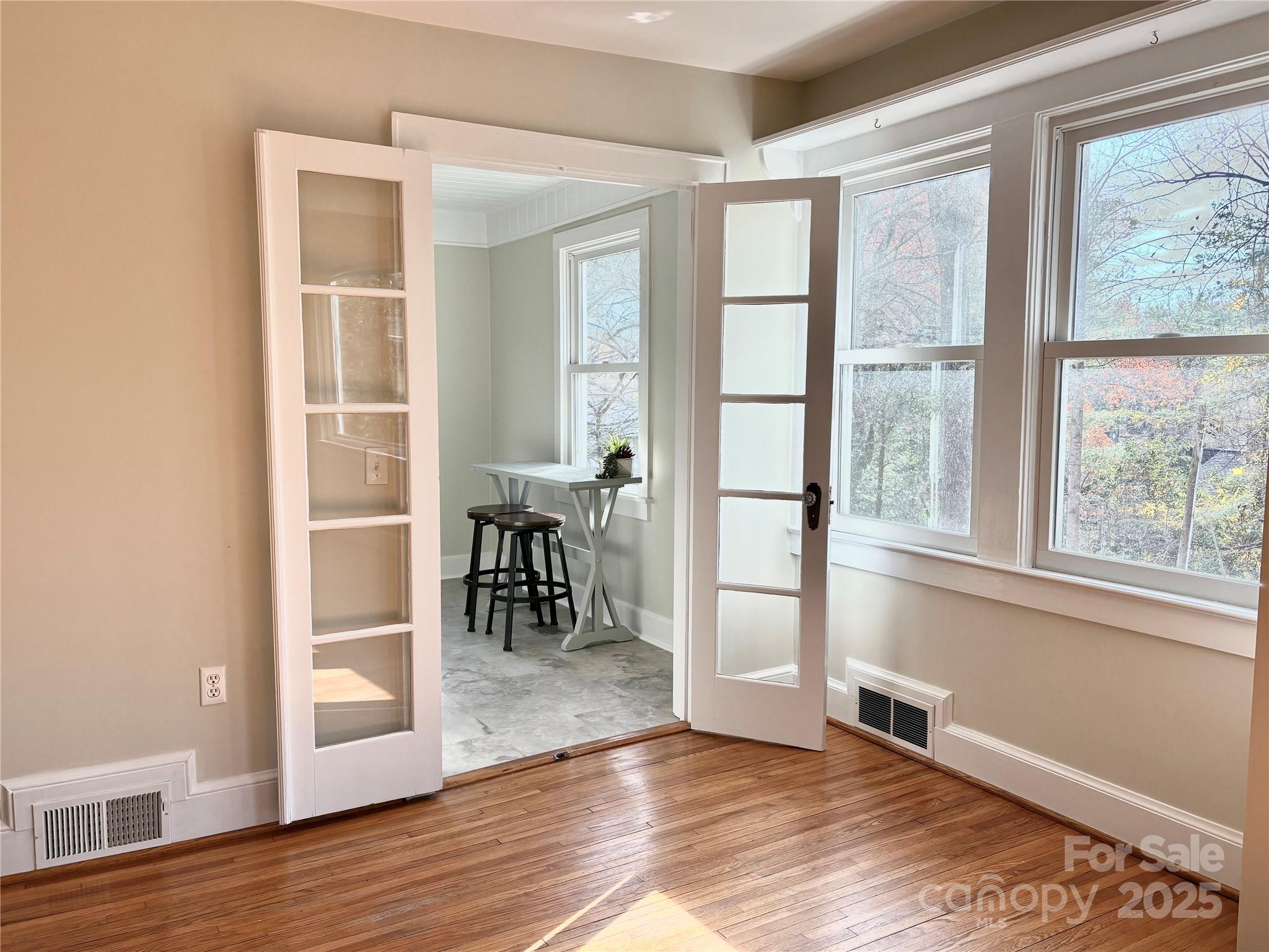 114 Broadway Tryon, NC 28782 - Photo 6 of 41 an empty room with wooden floor and windows
