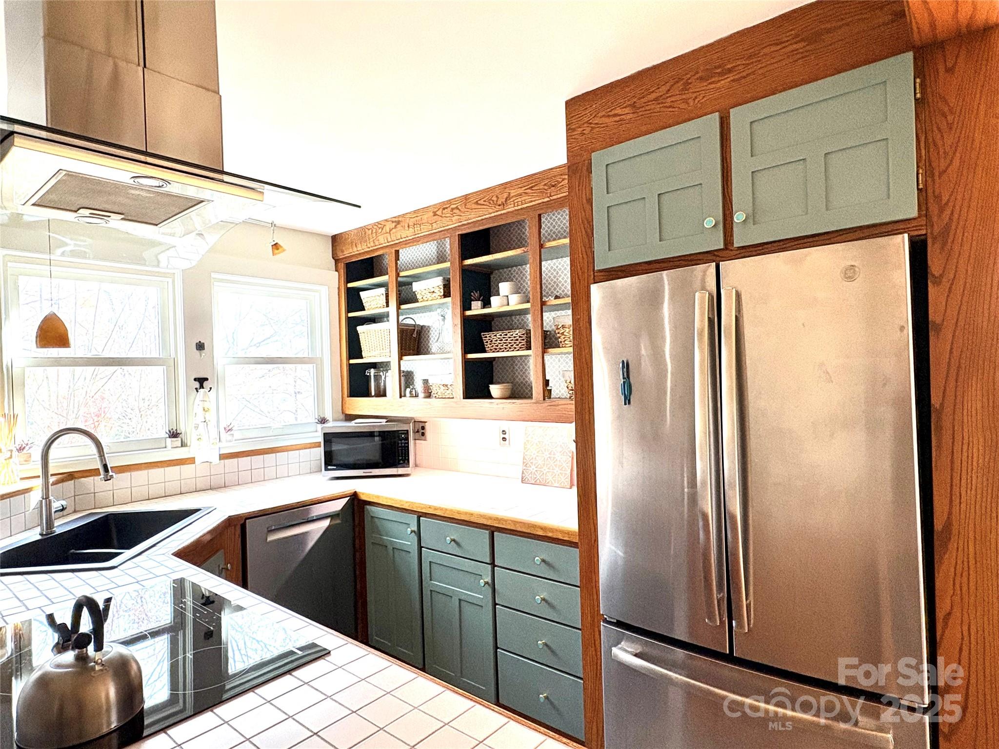 114 Broadway Tryon, NC 28782 - Photo 8 of 41 a kitchen with stainless steel appliances a sink and a refrigerator