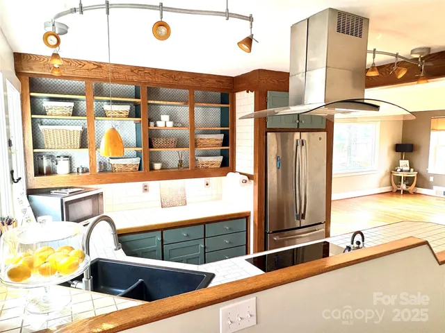 a living room with a fireplace and windows