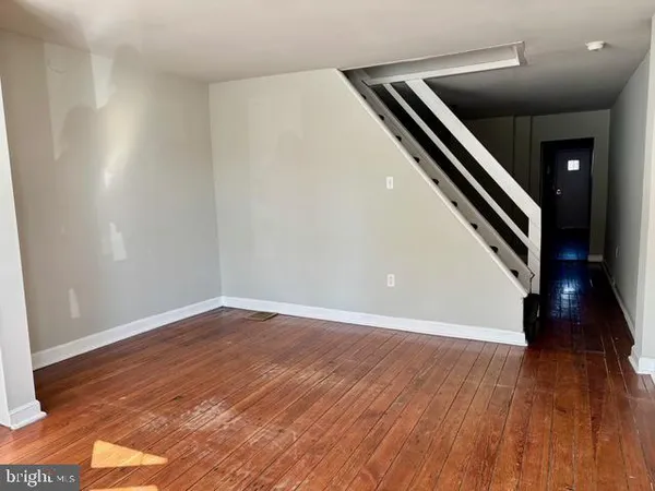 wooden floor in an empty room with an entryway