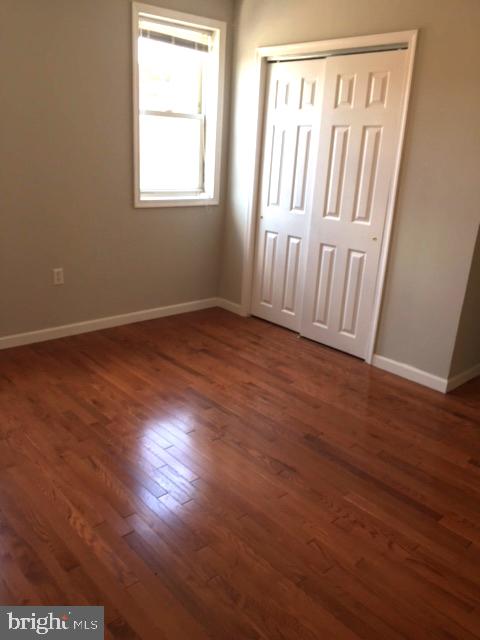2445 East Huntingdon Street Philadelphia, PA 19125 - Photo 12 of 24 an empty room with wooden floor and windows