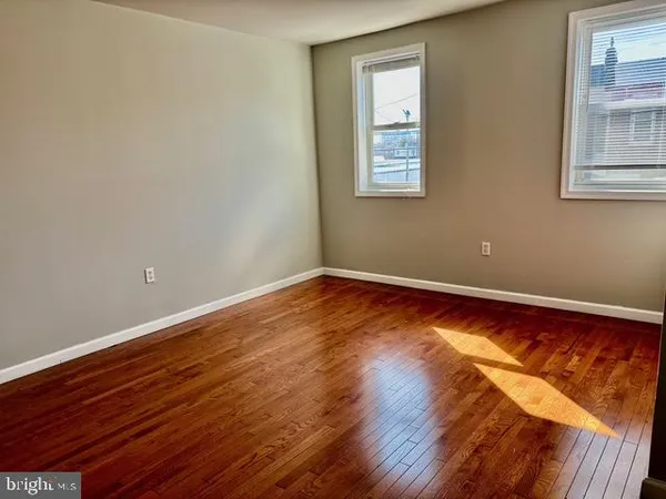 a view of a room with wooden floor and window