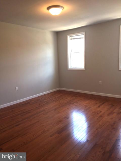 2445 East Huntingdon Street Philadelphia, PA 19125 - Photo 13 of 24 an empty room with wooden floor and windows